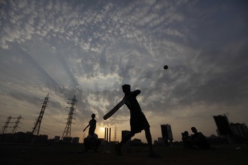 Childrens playing cricket on a cloudy sunset evening in Mumbai