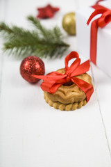 Christmas cookie, spruce branch, gift and balls.