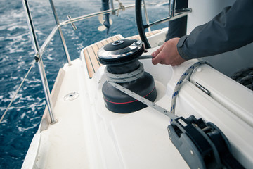 Sailor pulling rope, outdoor activities, sailboat sport race