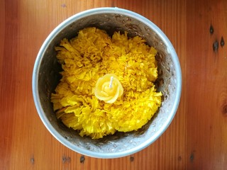 Marigold flowers and candle for making merit in Hinduism and Buddhism.