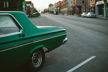 Vintage green car on city street