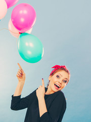 Fototapeta premium Smiling crazy girl having fun with balloons.