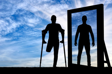 Silhouette of a man with an amputated leg with crutches