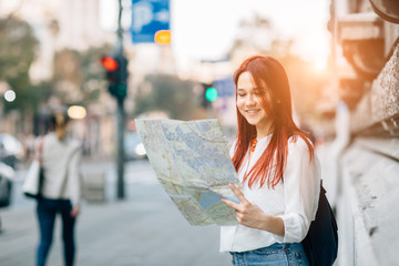 Young beautiful female traveler lost in the city
 