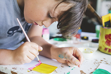 close up of a young boy / child painting