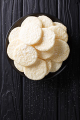 Delicious sweet rice cakes with sugar close-up on a plate. Vertical top view