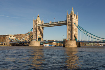 Fototapeta na wymiar Tower Bridge in London with blue sky and reflections in the river Thames.