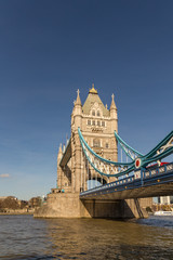 Fototapeta na wymiar Tower Bridge, vertical shot with the river and a blue sky.