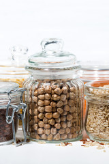 assortment of cereals and legumes on white background, vertical closeup