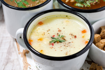 assortment of hot soups in mugs, closeup