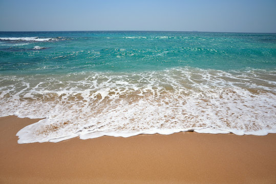 the waves of the Indian Ocean on a beautiful sand