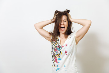 Fototapeta premium Beautiful European young funny and cheerful brown-haired woman with healthy clean skin, dressed in casual light clothes is fooling around at camera, on a white background. Emotions concept.