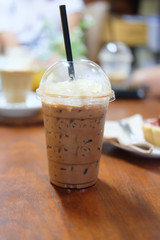 Ice cocoa with whipping cream on wood table