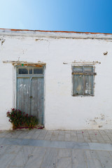 Fototapeta na wymiar old Door and window with white wall, vertical
