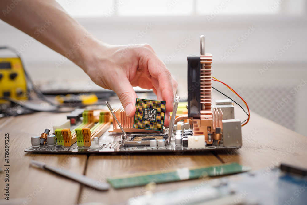 Poster Technician plug in microprocessor to motherboard