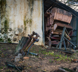 An antique threshing machine sits in a derelict barn on a farm in South Africa