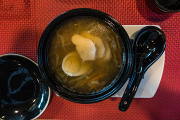 Tasty Japanese ramen soup bowl with pork, egg, and vegetables