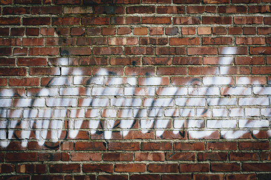 Graffiti on brick building wall