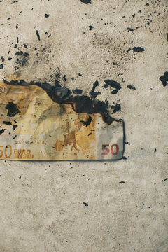Burning fifty euro banknote.