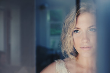 Beautiful Woman gazing out of window