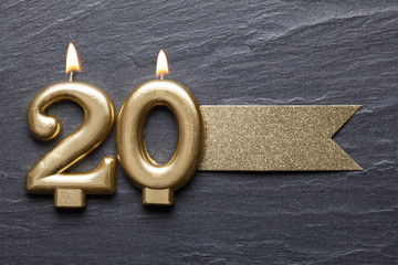 Gold number 20 celebration candle with glitter label