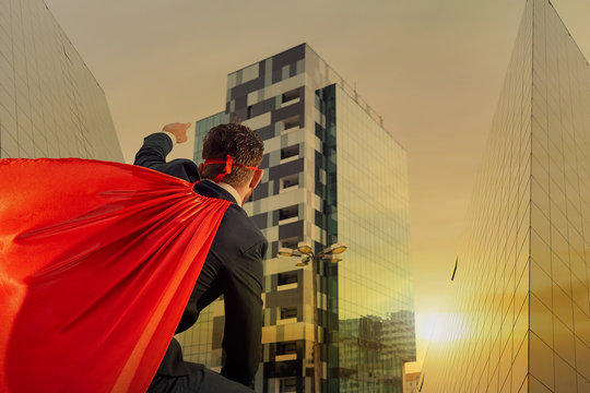 A Businessman Is A Superhero On A Business Building Background O