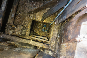 Miner on rope exploring the old mine shaft