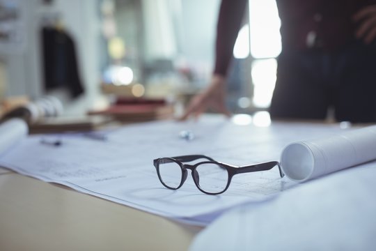 Close-up of spectacles on blueprint