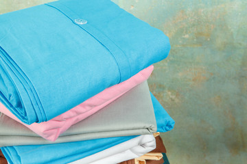 stacks colourful bed linen textiles clothing background pile concept