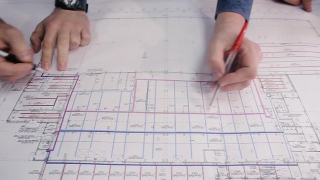 Engineer checks the data for the new project. Engineers are considering drawing
