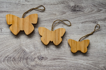 Three wooden toys in the form of butterflies.