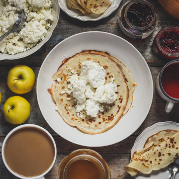 pancakes with cottage cheese and other sweet additives on the wood surface