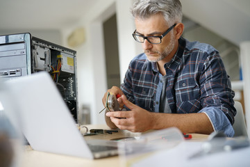 Technician repairing computer hardware