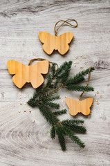 Christmas composition - fir branch, with butterflies made of wood and festive sweets