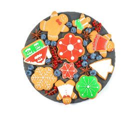 Plate with delicious Christmas cookies on white background