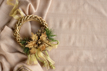 Golden christmas wreath on the fabric background ( horizontal)