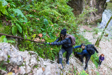 Hikers climbing on mountain wall
