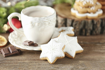 Creative Christmas cookies and cup of hot drink on table