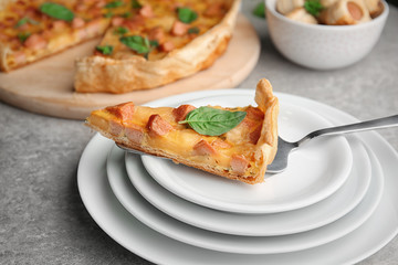 Shovel with slice of pizza on plates