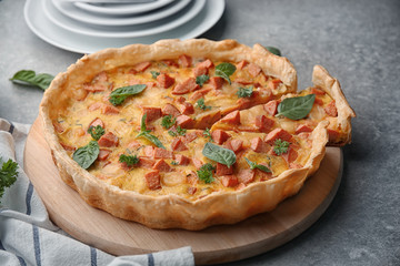 Delicious casserole with sausages on kitchen board
