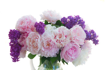 Fresh peony and lilac flowers buds colored in shades of pink close up isolated on white background