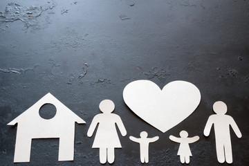 paper family on a black background with space for text