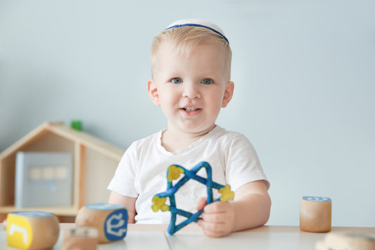 Little Jewish boy with Star of David at home