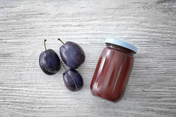 Jar with tasty baby food on wooden table