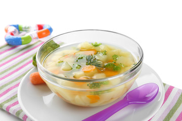 Bowl of delicious baby soup on table