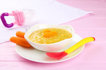 Plate of creamy baby vegetable soup on table