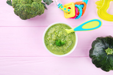 Bowl of creamy baby vegetable soup on wooden table