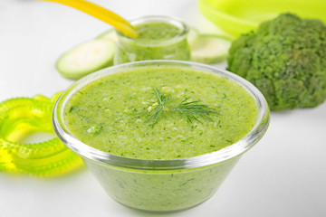 Bowl of creamy baby vegetable soup on table