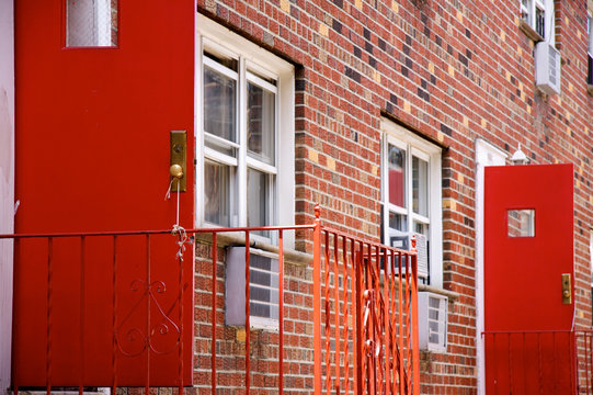 Red open door on a red brick building