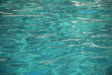 tourquise water of the sea, waves and reflections of the sun